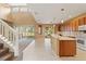 Open-concept living space featuring large windows, a soaring ceiling, and a modern kitchen with sleek appliances at 4335 Canongate Ct, Spring Hill, FL 34609