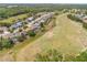 This is an aerial view of a community that borders a golf course and features mature trees at 4407 Caliquen Dr, Brooksville, FL 34604