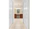 En suite bathroom featuring double vanity with dark wood cabinets, tile floors, and large mirrors at 4407 Caliquen Dr, Brooksville, FL 34604