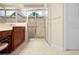 Bathroom with a double vanity, glass shower, and tile flooring at 4407 Caliquen Dr, Brooksville, FL 34604