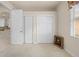 Carpeted bedroom featuring multiple closets and a view to the kitchen at 4407 Caliquen Dr, Brooksville, FL 34604