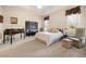Cozy bedroom featuring a tray ceiling, sitting area, and vintage accents at 4407 Caliquen Dr, Brooksville, FL 34604