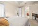 Bright bedroom with neutral walls, carpet and trim, featuring a view to an en suite bathroom at 4407 Caliquen Dr, Brooksville, FL 34604