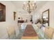 Bright dining room with chandelier and glass table, flowing into the living area at 4407 Caliquen Dr, Brooksville, FL 34604