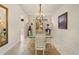 Elegant dining room with glass table, chandelier, and decorative wall sconces at 4407 Caliquen Dr, Brooksville, FL 34604
