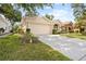 Well maintained lawn leads up to this home with neutral paint and a 2 car garage at 4407 Caliquen Dr, Brooksville, FL 34604