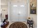 Gracious foyer featuring a double door entry, tile floors, and decorative columns at 4407 Caliquen Dr, Brooksville, FL 34604