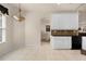 Eat-in kitchen features tile flooring, white cabinets, and a window for natural light at 4407 Caliquen Dr, Brooksville, FL 34604