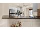 Modern kitchen equipped with granite countertops, stainless steel appliances, and white cabinets at 4407 Caliquen Dr, Brooksville, FL 34604
