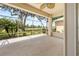Open-air lanai providing views of the surrounding community and mature landscaping at 4407 Caliquen Dr, Brooksville, FL 34604