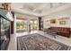 Bright living room boasts fireplace, tile floor, and sliding doors to the outdoor area at 4407 Caliquen Dr, Brooksville, FL 34604