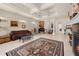Open-concept living room with tile flooring, coffered ceiling, and large windows at 4407 Caliquen Dr, Brooksville, FL 34604
