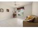 Comfortable office space featuring a sofa, desk, and natural light from the window at 4407 Caliquen Dr, Brooksville, FL 34604