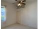Bedroom featuring carpet, a window, and a ceiling fan with light fixture at 4450 Anaconda Dr, New Port Richey, FL 34655