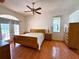 Spacious bedroom with wood floors, a ceiling fan, and access to the backyard at 4450 Anaconda Dr, New Port Richey, FL 34655
