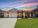 Charming single-story home with a three-car garage, red brick accents, and a well-manicured lawn at 4450 Anaconda Dr, New Port Richey, FL 34655