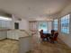 Open floor plan combines kitchen and dining area overlooking the enclosed pool at 4450 Anaconda Dr, New Port Richey, FL 34655