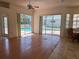 Bright living room featuring wood floors and sliding doors leading to the pool at 4450 Anaconda Dr, New Port Richey, FL 34655