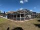 Backyard view of the screened-in pool area, perfect for outdoor enjoyment at 4450 Anaconda Dr, New Port Richey, FL 34655