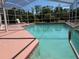 Close-up view of the screened in pool with lounge chair at 4450 Anaconda Dr, New Port Richey, FL 34655