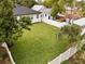 Large fenced backyard with lush lawn, bordered by mature landscaping, and privacy fence at 461 Pent St, Tarpon Springs, FL 34689