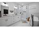 Bright bathroom with marble floors, soaking tub, frameless glass shower, and double sink vanity at 461 Pent St, Tarpon Springs, FL 34689