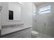 Modern bathroom with glass shower, white countertops, and sleek fixtures at 461 Pent St, Tarpon Springs, FL 34689