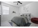 Bedroom features a stylish gray bed, modern ceiling fan and cozy rug at 461 Pent St, Tarpon Springs, FL 34689
