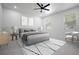 Bedroom with a gray bed, modern ceiling fan and ample sunlight from the windows at 461 Pent St, Tarpon Springs, FL 34689