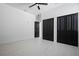 Minimalist bedroom featuring hardwood flooring, modern ceiling fan, and abundant closet space at 461 Pent St, Tarpon Springs, FL 34689
