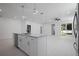 Bright open kitchen featuring stainless steel appliances, a large island and connection to the backyard at 461 Pent St, Tarpon Springs, FL 34689