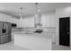 Modern kitchen with stainless steel appliances, sleek white cabinetry, and a center island with a countertop at 461 Pent St, Tarpon Springs, FL 34689
