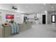 Bright, open-concept living room flows into the modern kitchen with stainless steel appliances and sleek white cabinetry at 461 Pent St, Tarpon Springs, FL 34689