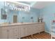 Bathroom with a large mirror, double sinks, ample counter space, and bright lighting at 473 Tournament Dr, Spring Hill, FL 34608