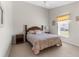 Cozy bedroom featuring a classic wooden bed frame and a sunny window at 473 Tournament Dr, Spring Hill, FL 34608