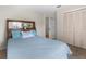 Bright bedroom featuring a wood-framed headboard, large windows, and ample closet space at 473 Tournament Dr, Spring Hill, FL 34608