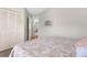 Comfortable bedroom showcasing a bed with a patterned comforter and an open closet space at 473 Tournament Dr, Spring Hill, FL 34608