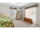 This bedroom features natural light, plush carpet, and neutral walls at 473 Tournament Dr, Spring Hill, FL 34608