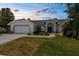 Charming single-story home with a well-manicured lawn, two-car garage, and a lovely blue trim at 473 Tournament Dr, Spring Hill, FL 34608