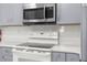 Close-up of the kitchen appliances, featuring a stove with white subway tile backsplash at 473 Tournament Dr, Spring Hill, FL 34608