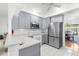 Bright kitchen featuring modern appliances, quartz countertops, and new cabinetry at 473 Tournament Dr, Spring Hill, FL 34608