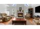 Comfortable living room features a fireplace, vaulted ceiling, and hardwood floors at 473 Tournament Dr, Spring Hill, FL 34608