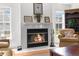 Cozy living room showcasing a fireplace, comfortable chair and a view to the back yard at 473 Tournament Dr, Spring Hill, FL 34608