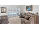 Cozy living room with comfortable seating and sliding glass doors overlooking the pool area at 473 Tournament Dr, Spring Hill, FL 34608