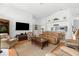 Bright living room featuring a high ceiling, comfortable furnishings, and an open flow to the kitchen at 473 Tournament Dr, Spring Hill, FL 34608