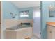 Bright main bathroom with a soaking tub, separate glass-enclosed shower, and modern fixtures at 473 Tournament Dr, Spring Hill, FL 34608