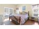 Comfortable main bedroom with vaulted ceilings, lots of light, a large bed and access to the outdoors at 473 Tournament Dr, Spring Hill, FL 34608