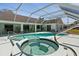 Enjoy a sparkling pool and jacuzzi with a covered lanai, perfect for relaxation and entertaining at 473 Tournament Dr, Spring Hill, FL 34608