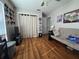 This spacious bedroom features wood-look flooring, a futon, and a closet at 5045 Musselshell Dr, New Port Richey, FL 34655