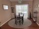 Dining room featuring a round woven rug, a view of the pool, and lots of natural light at 5045 Musselshell Dr, New Port Richey, FL 34655